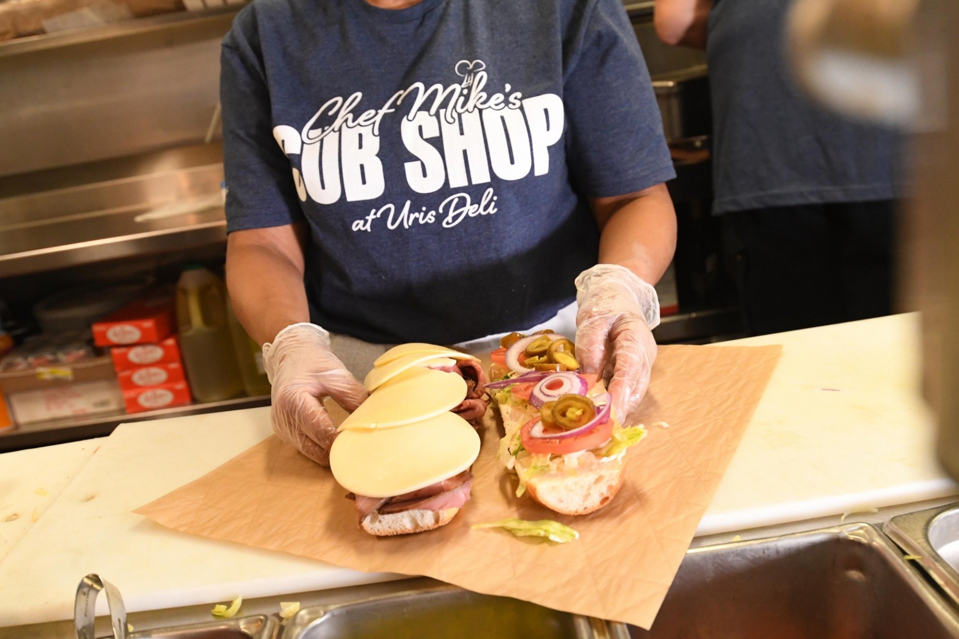 Staff member preparing a sandwich
