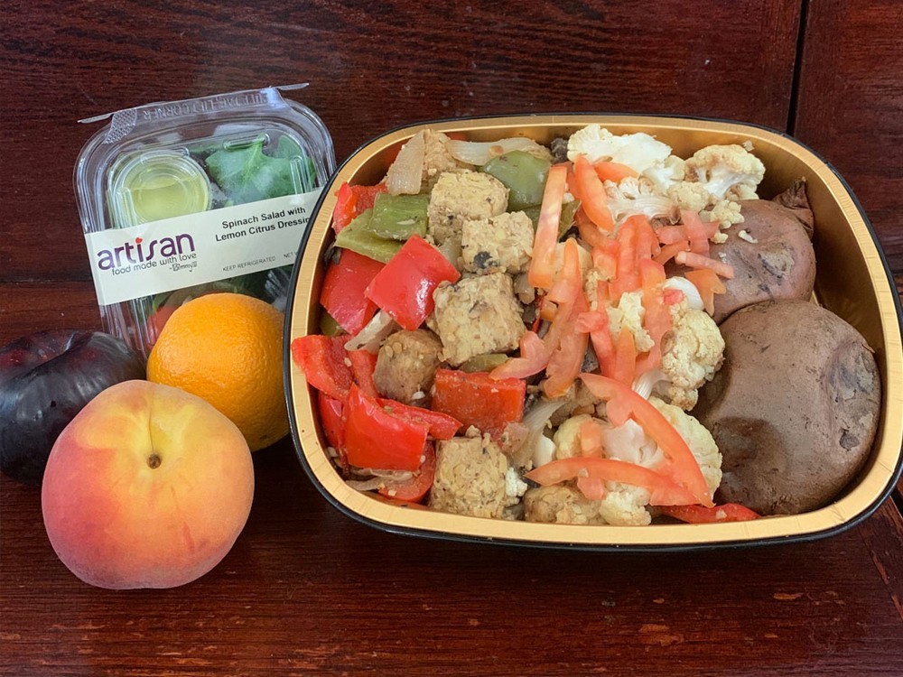 A vegetarian/vegan meal delivered during quarantine. (Photo: Campus Services) A vegetarian/vegan meal prepared for students during the delivery period including a salad, a plum, peach, and orange.