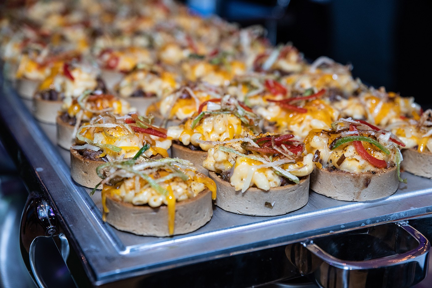 Mini pot pie: braised short rib and mac and cheese in a pastry shell Cups of mac and cheese in rows