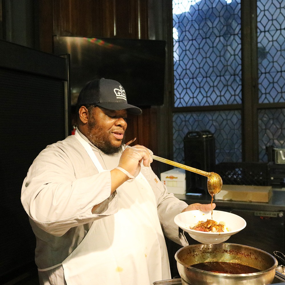 Gotta get that drizzle *just* right Amin ladling boil into a bowl