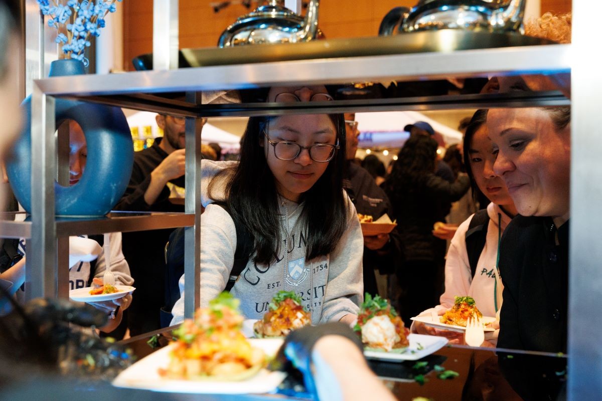 Students take food from the Faculty House tent