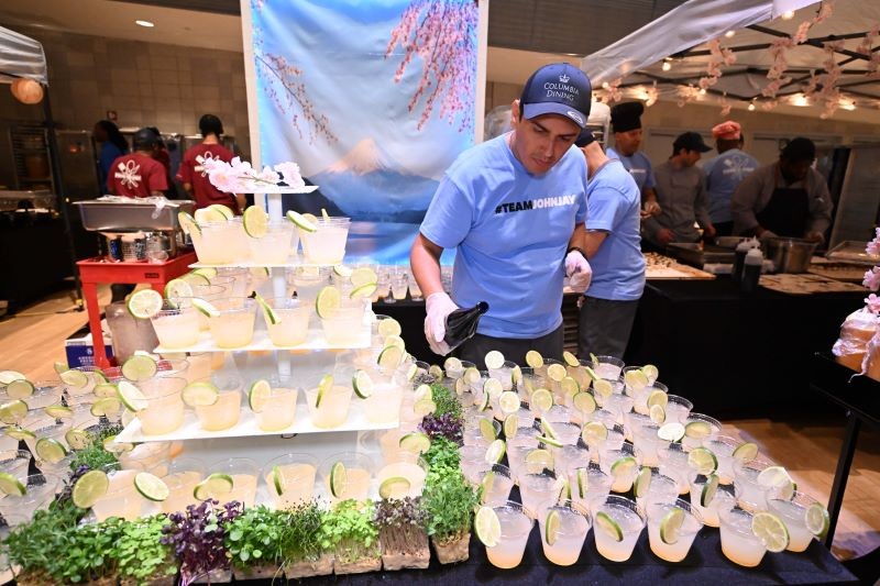 A dining staff member tops off cups of yuzu fizz