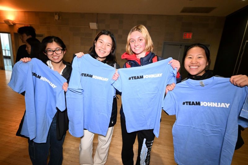 Students holding t-shirts