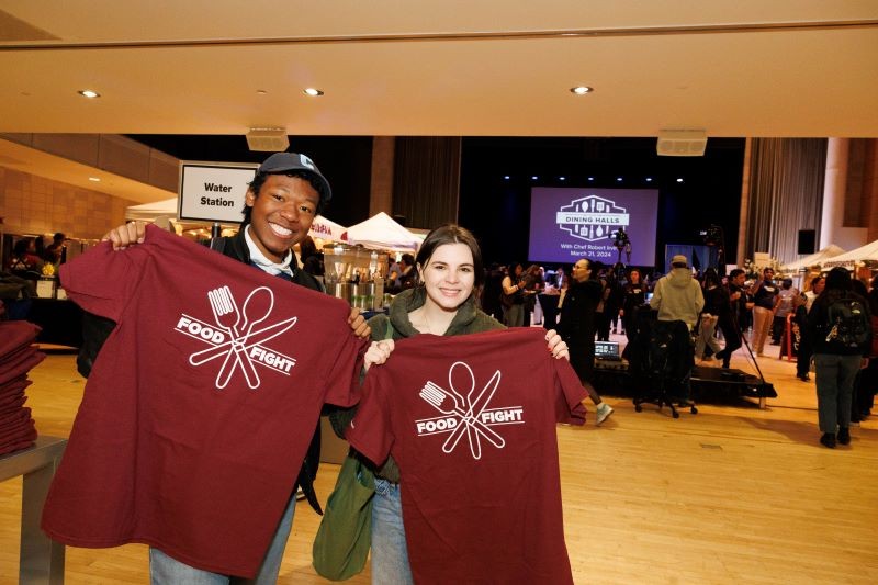 Students holding t-shirts