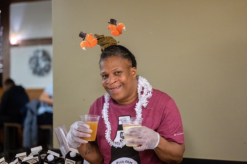 The only thing sweeter than egg nog and apple cider is Rhonda. Rhonda holding seasonal beverages