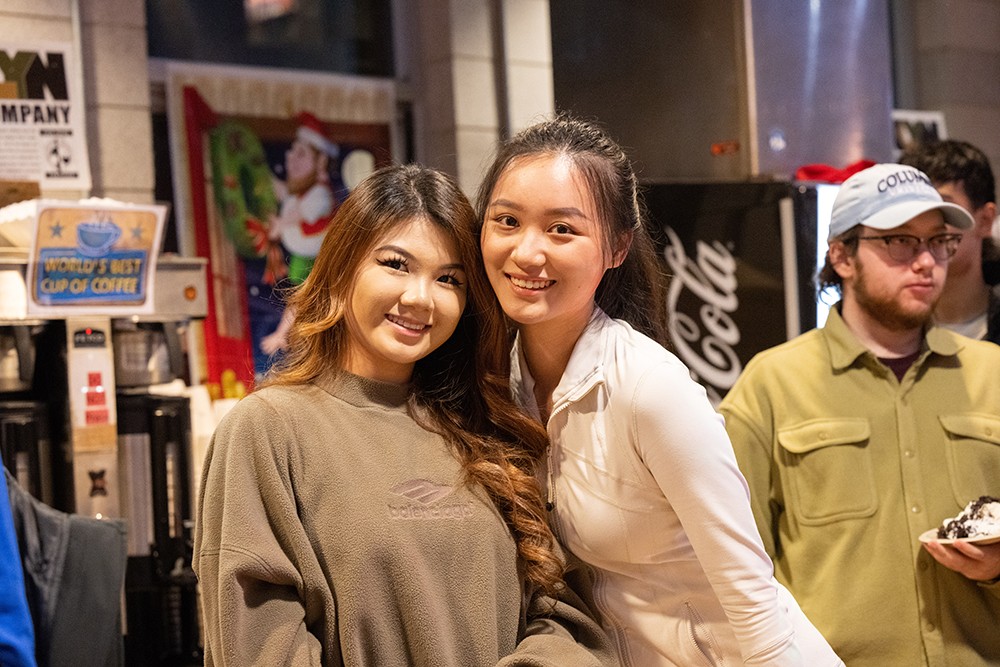 Holidays are better together! Two students stand in the Ferris servery