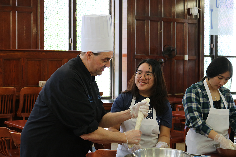 Chef Don shows a student how to stretch the mozzarella. Chef Don demonstrates how to stretch the mozzarella