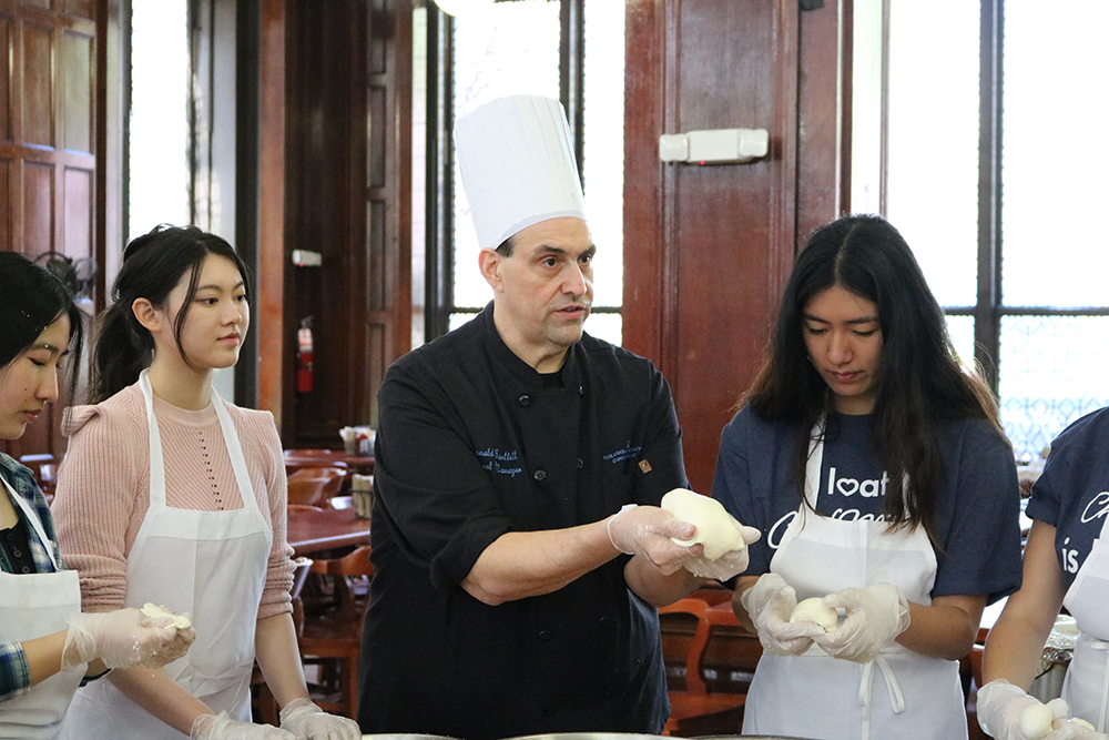 Chef Don demonstrating how to stretch the mozzarella