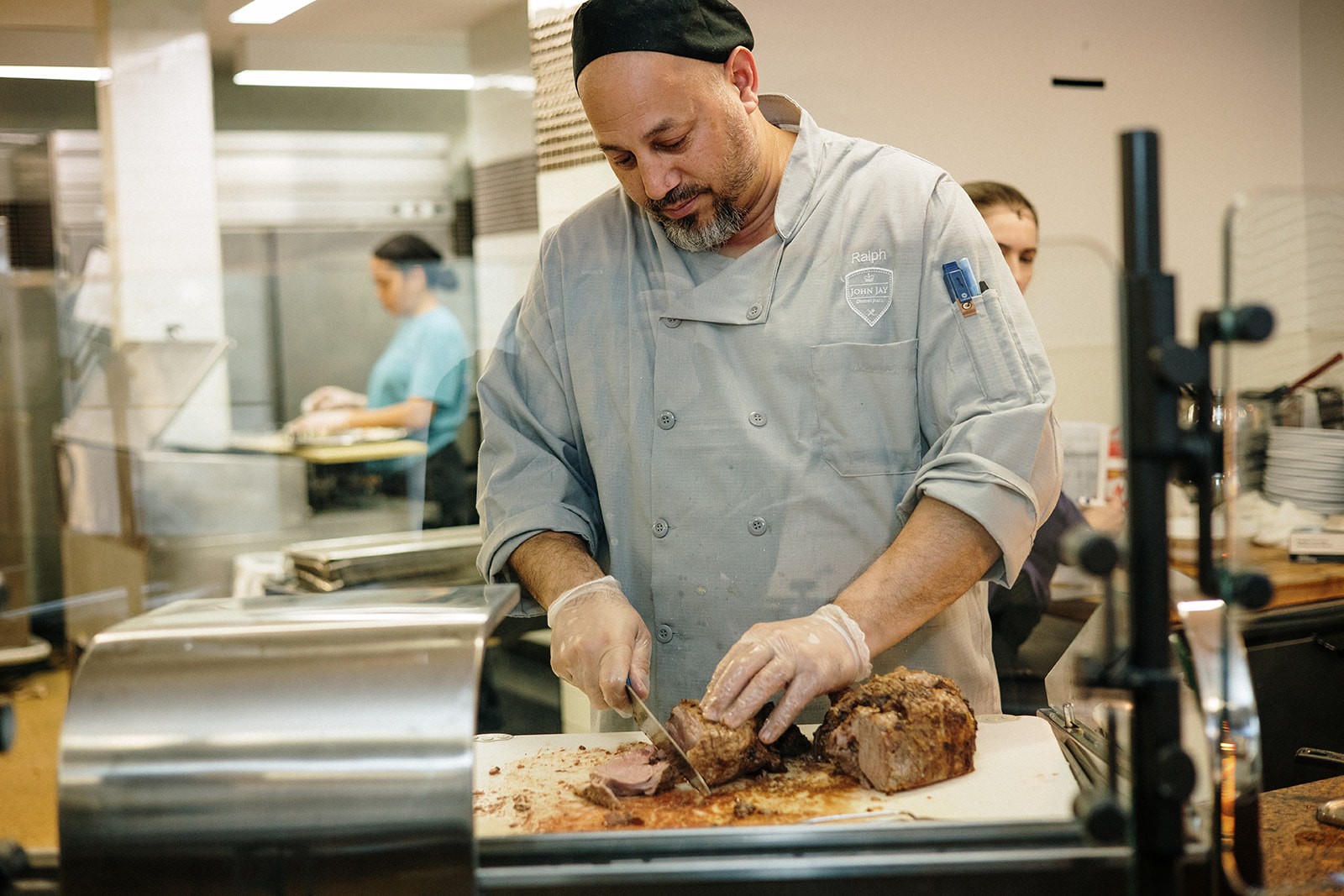 Ralph carved Roast Lamb at the action station; photo by April Renae