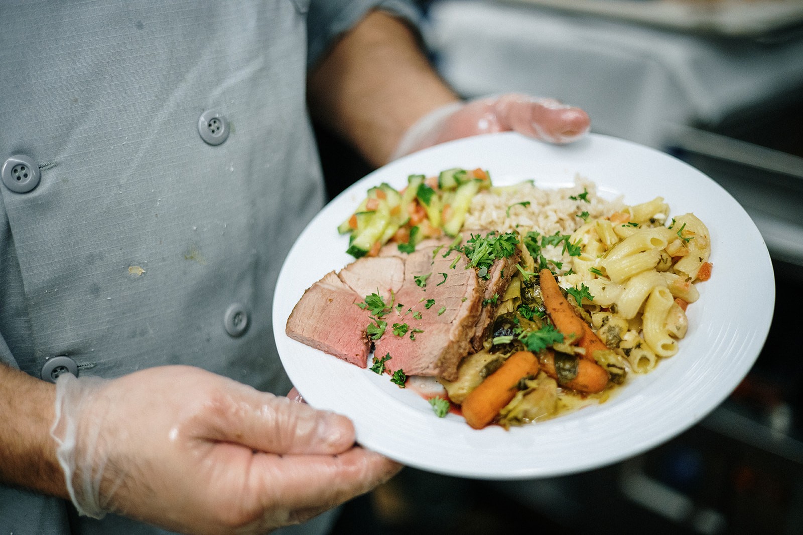 Roasted Lamb with vegetables and pasta salad; photo by April Renae