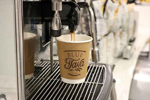 Blue Java Coffee cup being filled with coffee