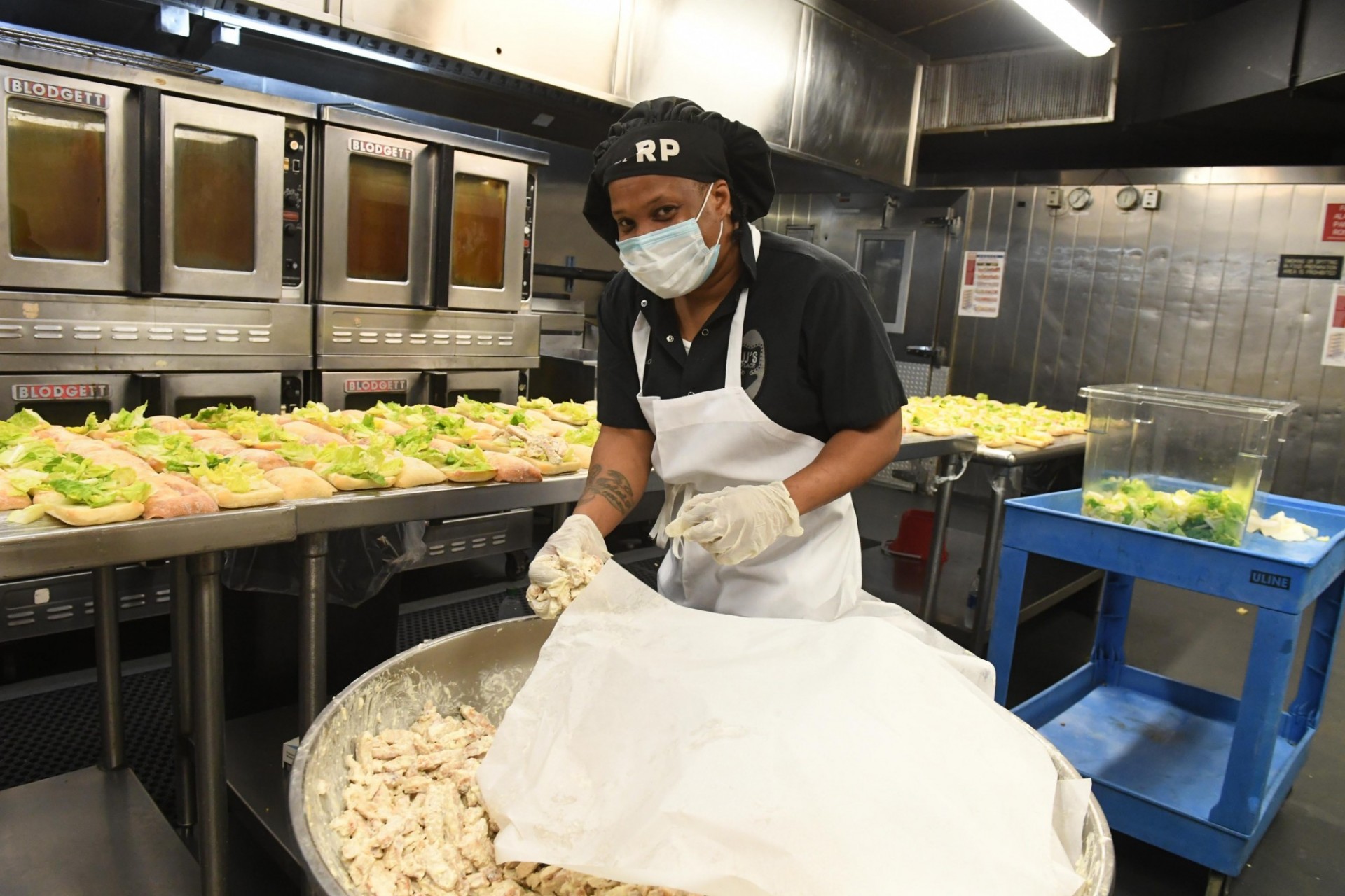 Dining staff member prepares food in John Jay Dining Hall