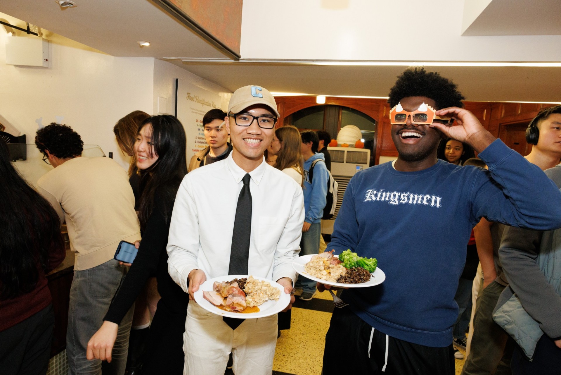 Clear eyes, full plates, can't lose students smiling with food