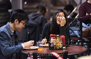 students laughing over dinner