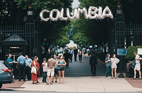 baloons spelling the word "columbia" hang on the Columbia University gates