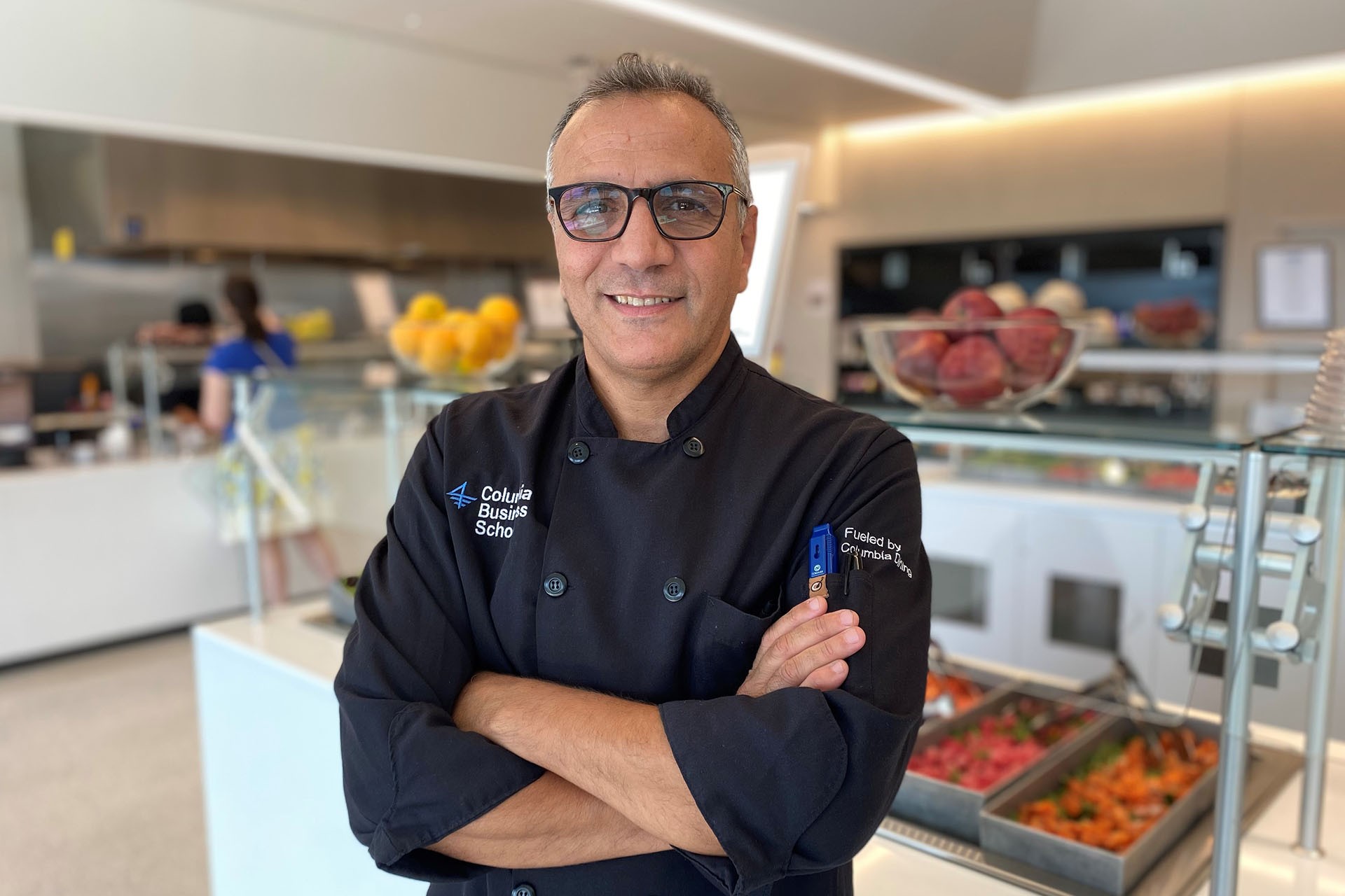 Photograph of Chef Baja in front of food service bar in the dining hall