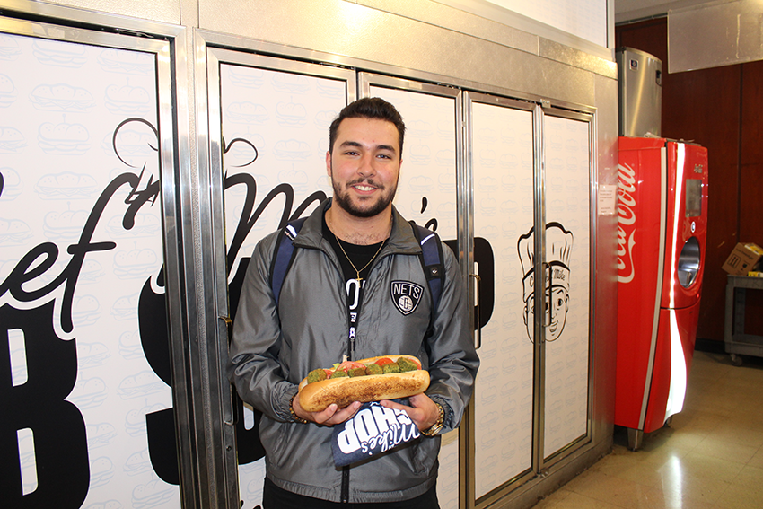 Zaid holding the falafel sub