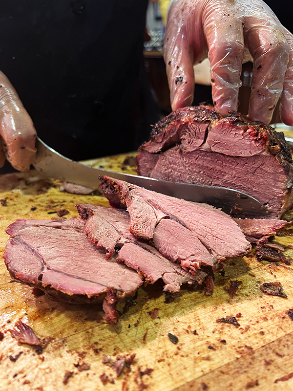 If turkey isn't your thing, we gotchu. Ferris served roasted lamb! Lamb being carved on a wooden board