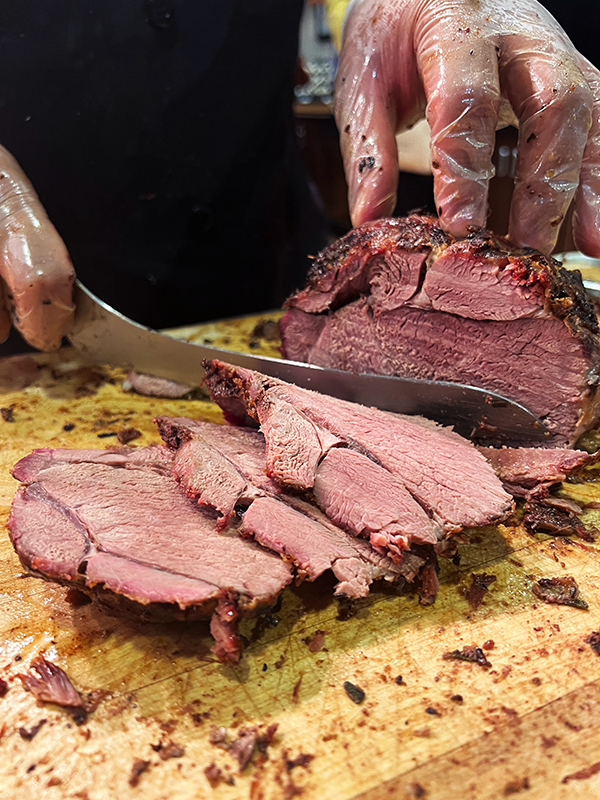 Lamb being carved on a wooden board