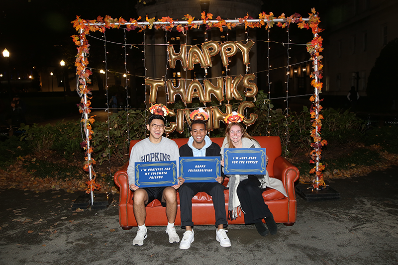 Students sitting on the couch at the photo booth