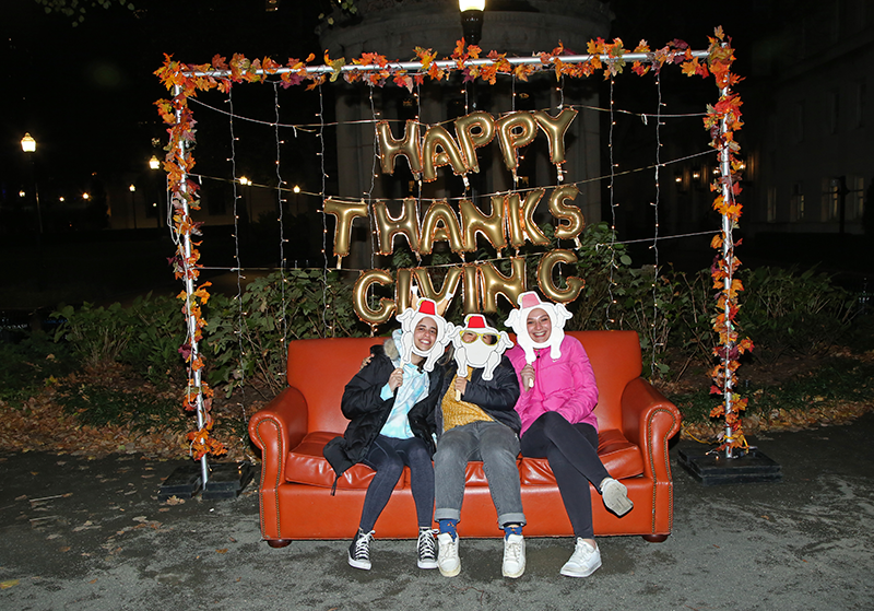 Students sitting on the couch at the photo booth