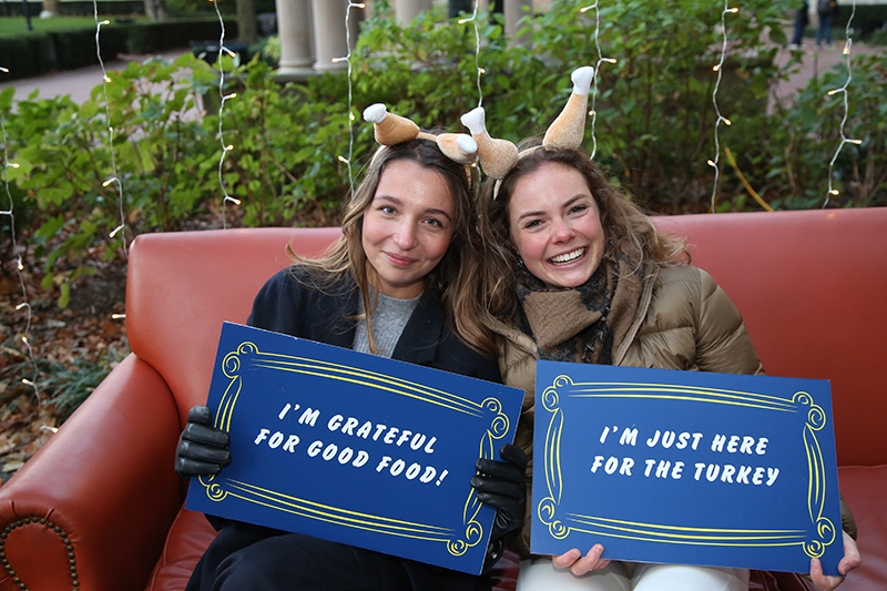 Students sitting on the couch at the photo booth