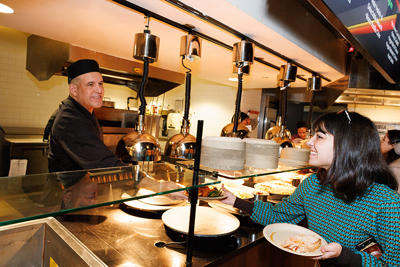 Thanks for the food, German! A ferris worker serves a student