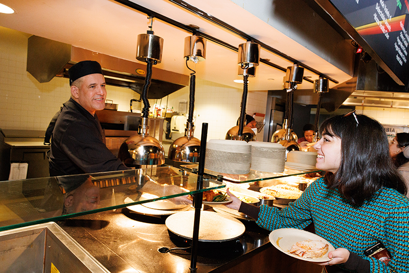 A ferris worker serves a student