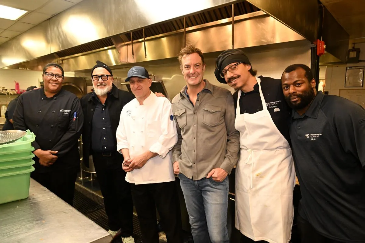 Andrew Zimmern and Barton Seaver greet members of the Columbia Dining culinary team