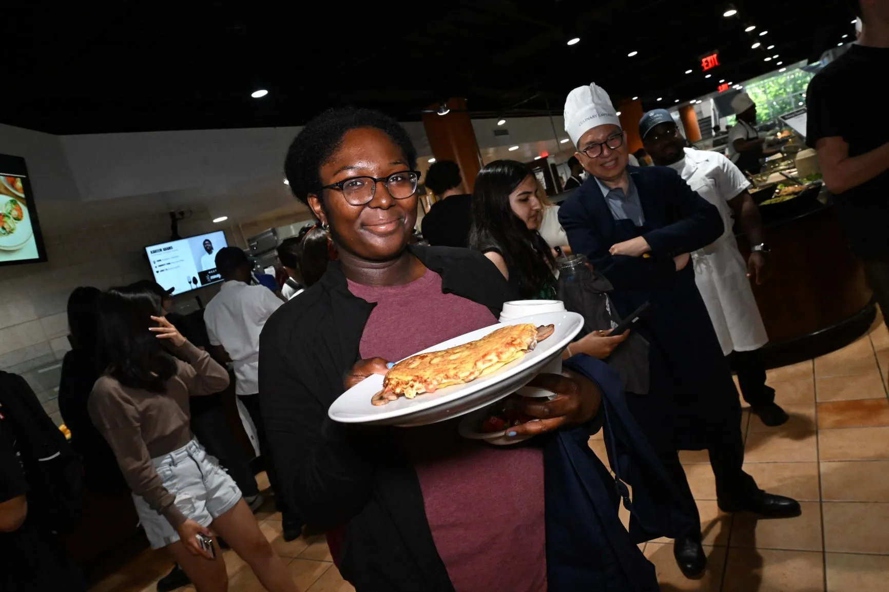 A students shows off their omelet