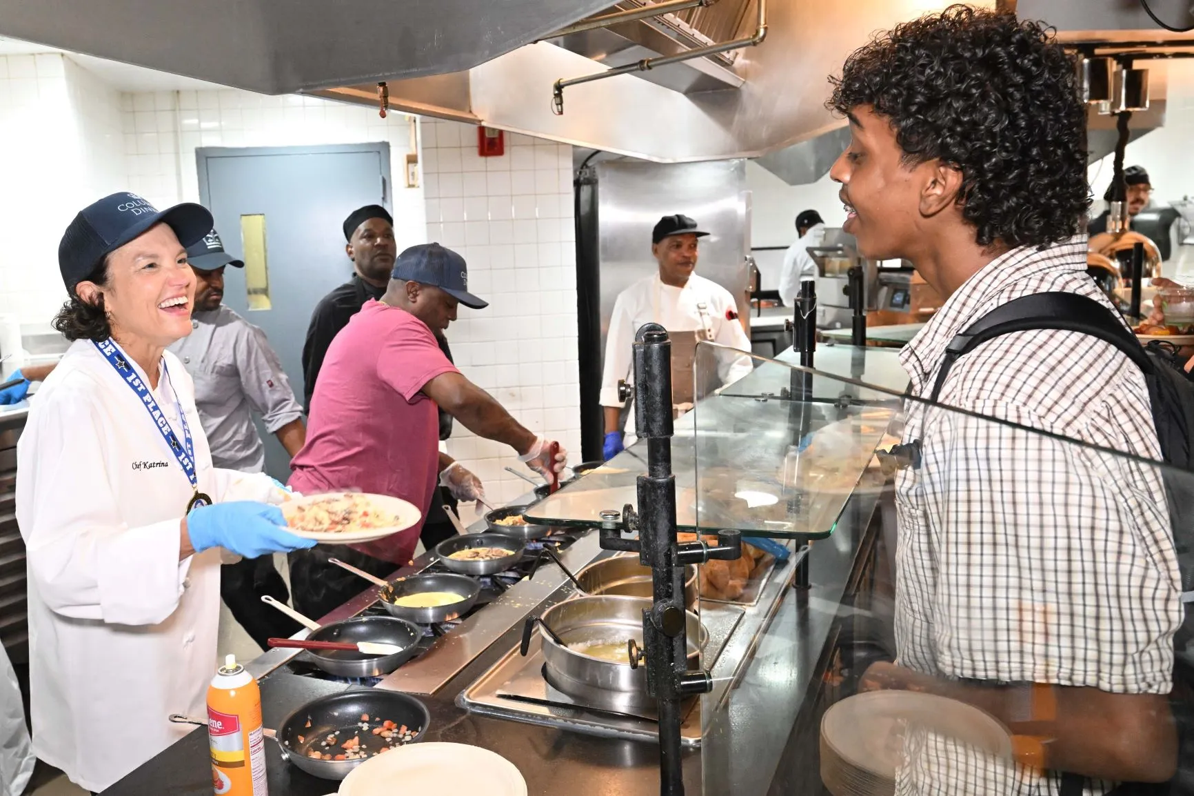 President Armstrong surprised students by cooking and serving omelets alongside the Dining team