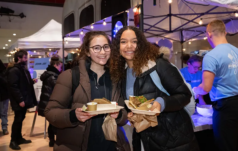 Two students smiling at the camera