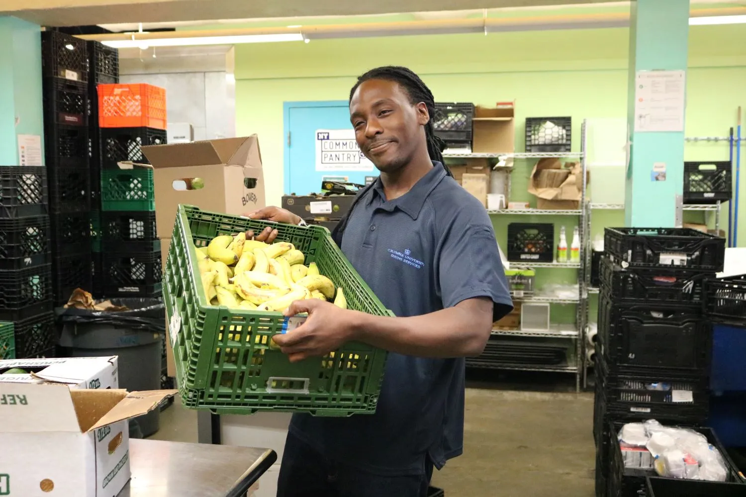Justin holds a crate of bananas