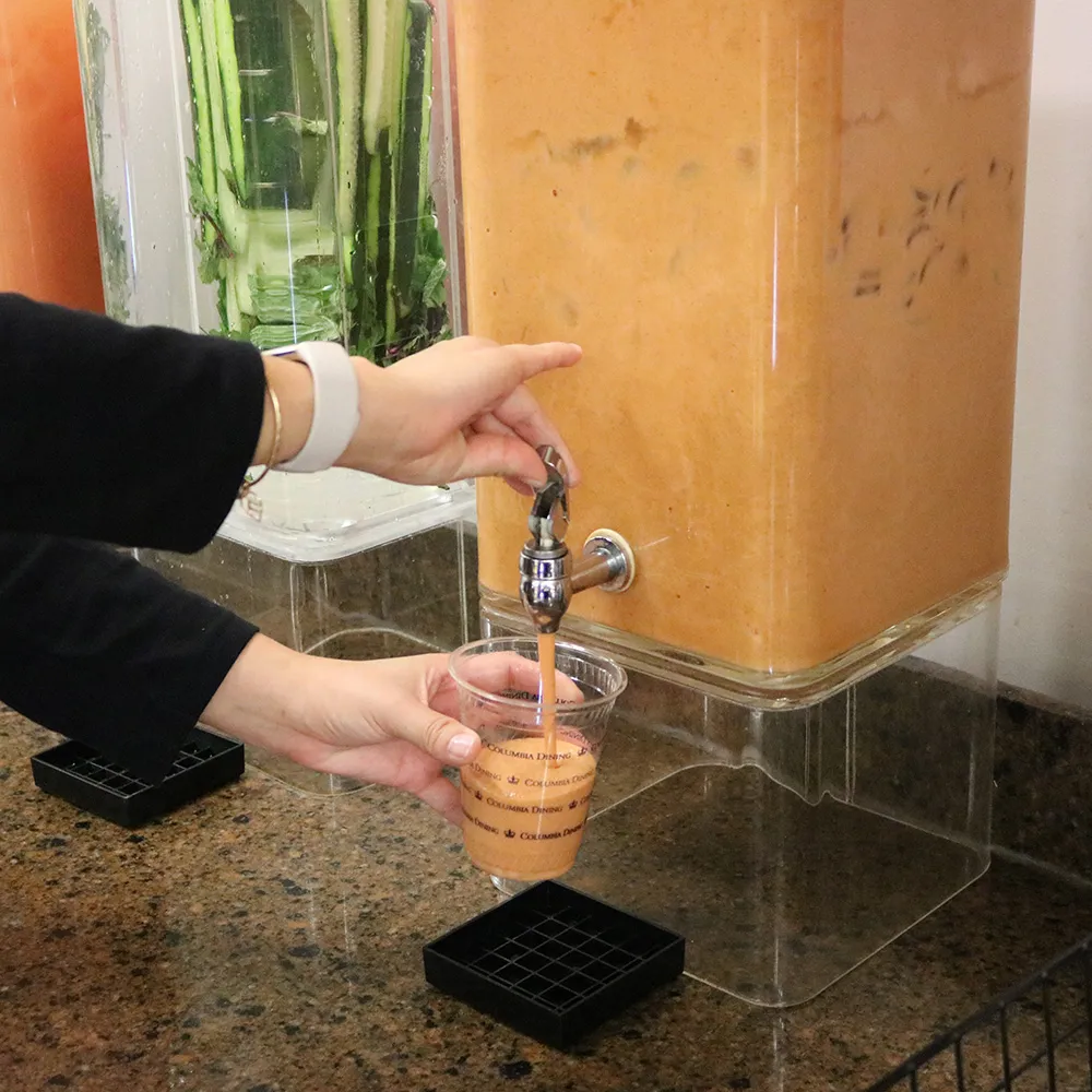 Carrot juice being poured into a cup