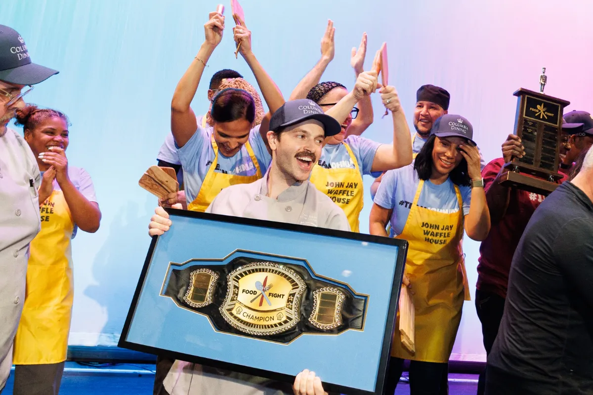 Chef Tom holding Champion Belt