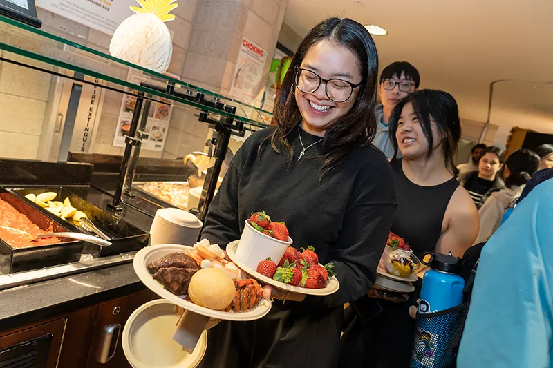 A student carrying a plate of food at Ferris