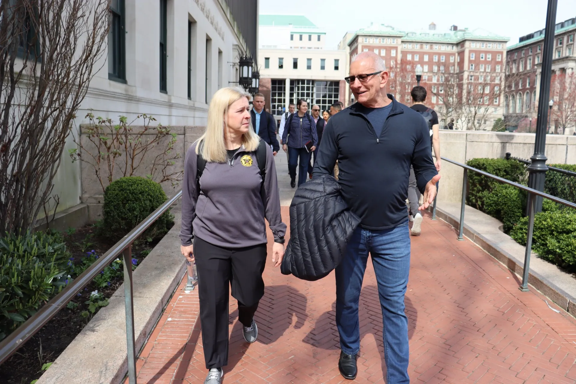 Robert Irvine walking with US Army representatives on tour