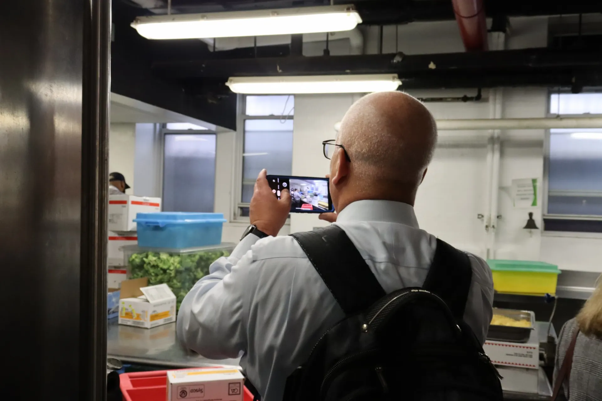 A US Army representative taking a picture of the kitchen while on the tour