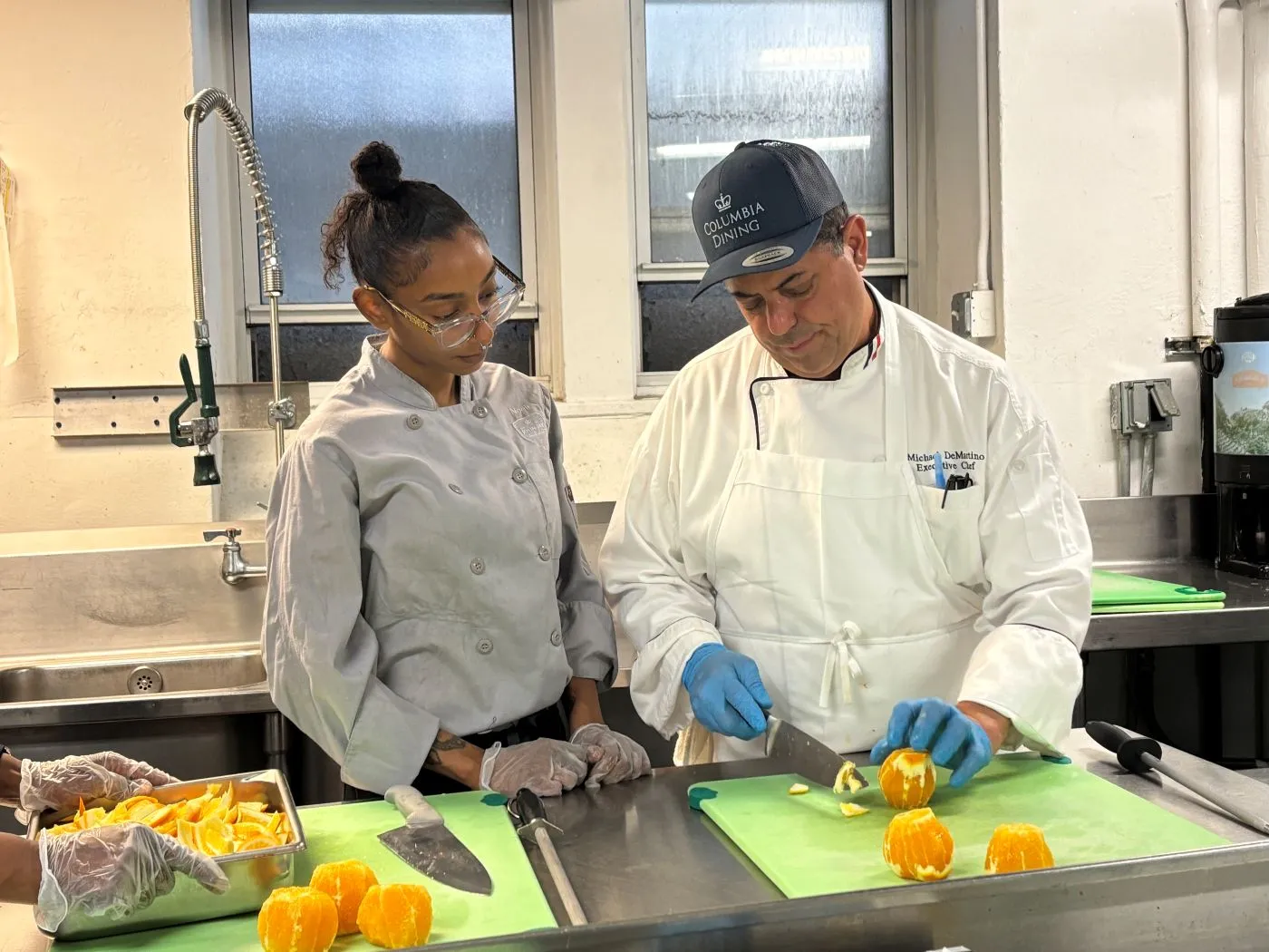 Chef and staff at cutting board