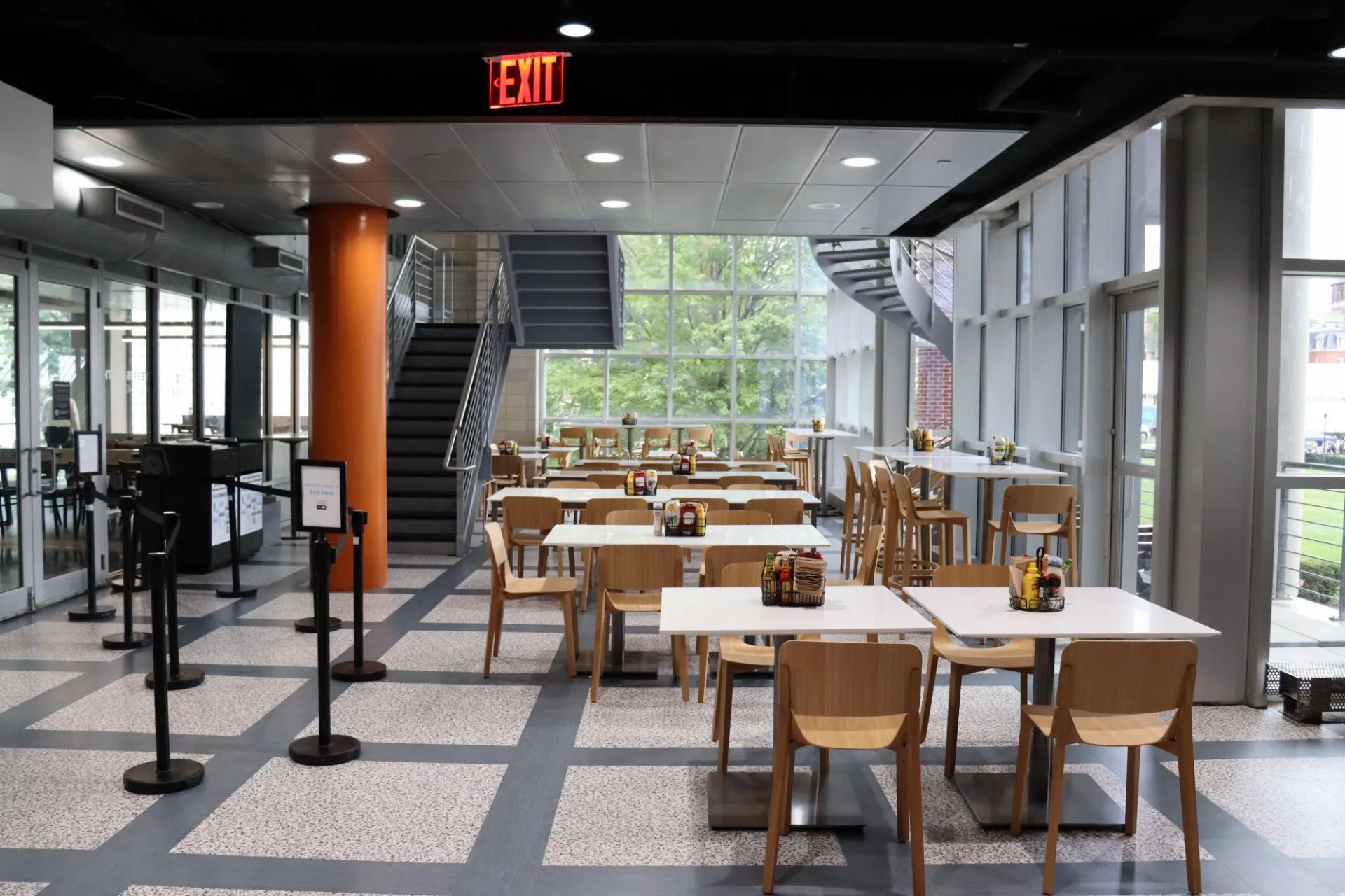 Ferris Booth Commons seating area featuring new white tables with light wood chairs