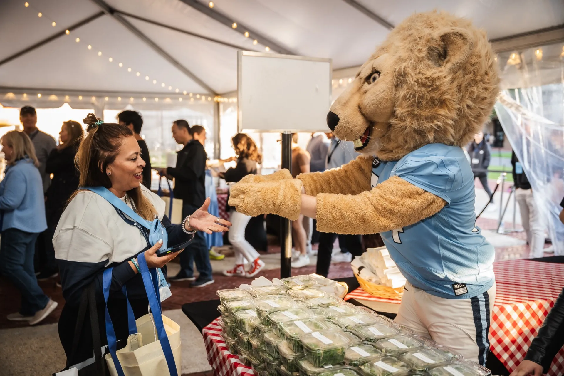 Roaree, school mascot, handing our Arugula Salad