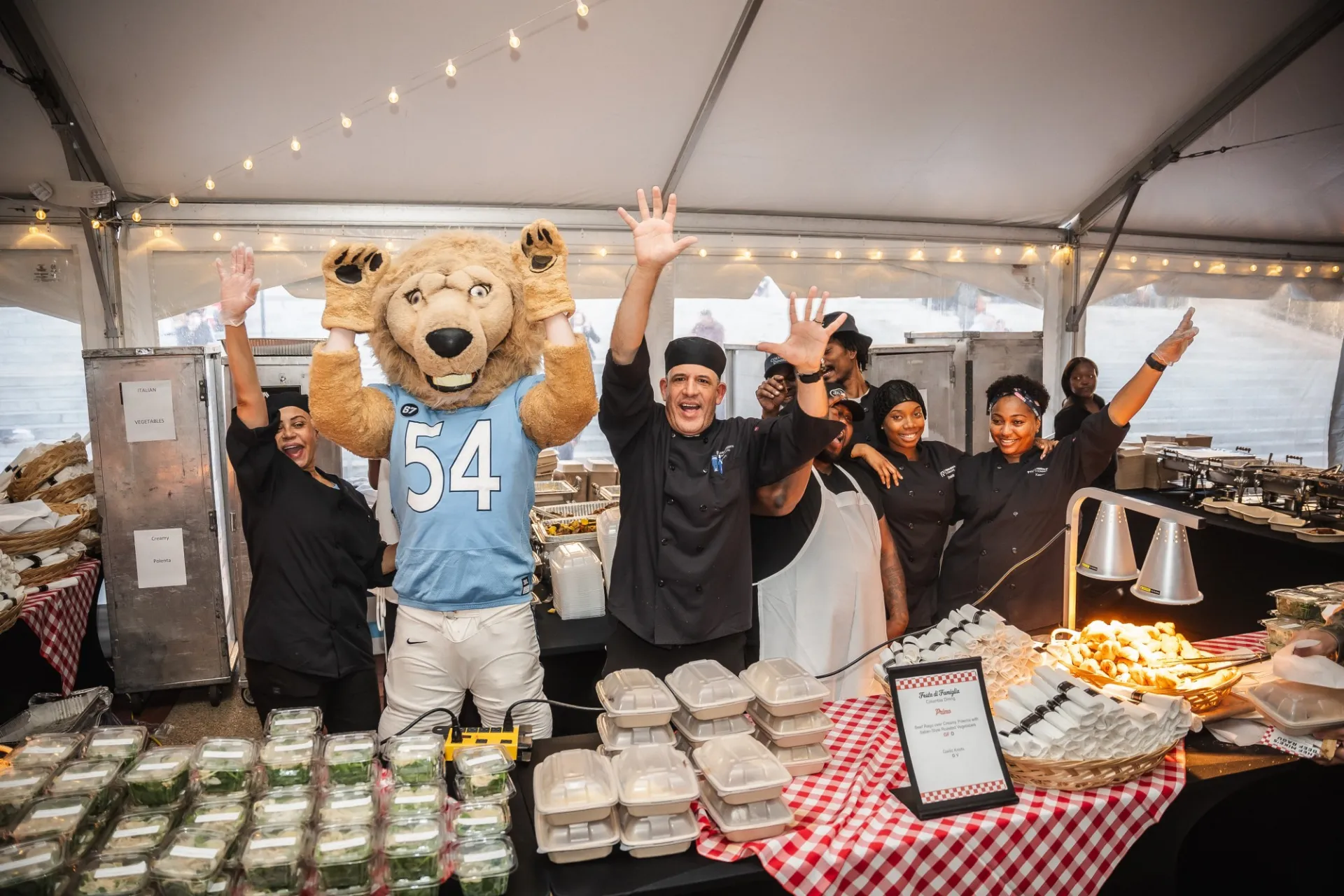 Roaree with dining staff waving
