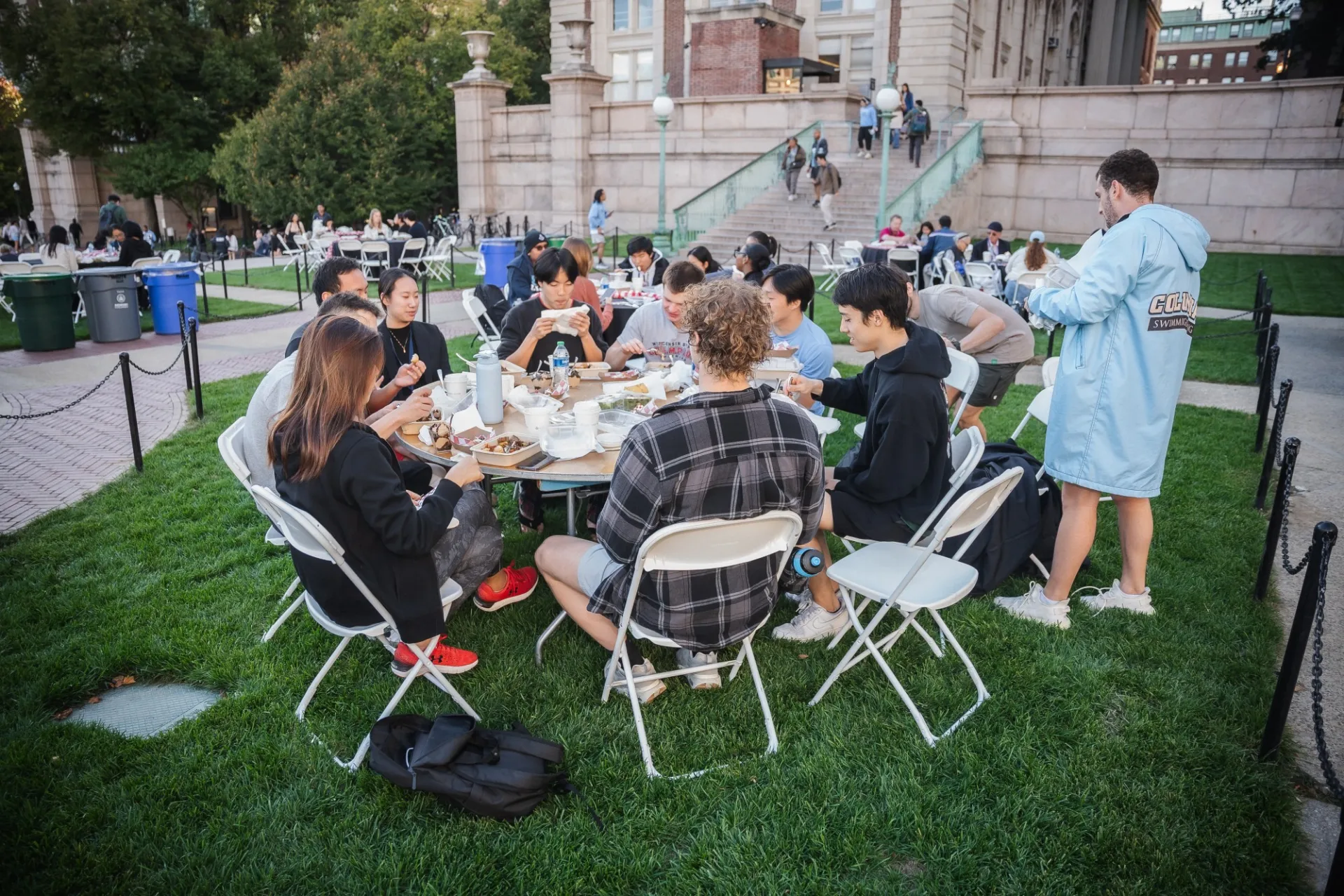 students eating together on the lawn 