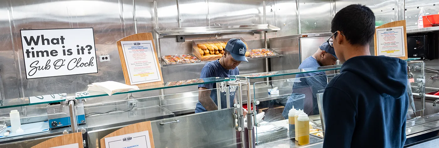 a student at the Chef Mike's Sub Shop counter