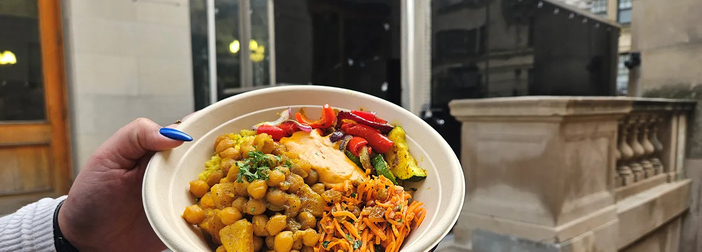 a bowl of chickpea tagine held in front of the truck
