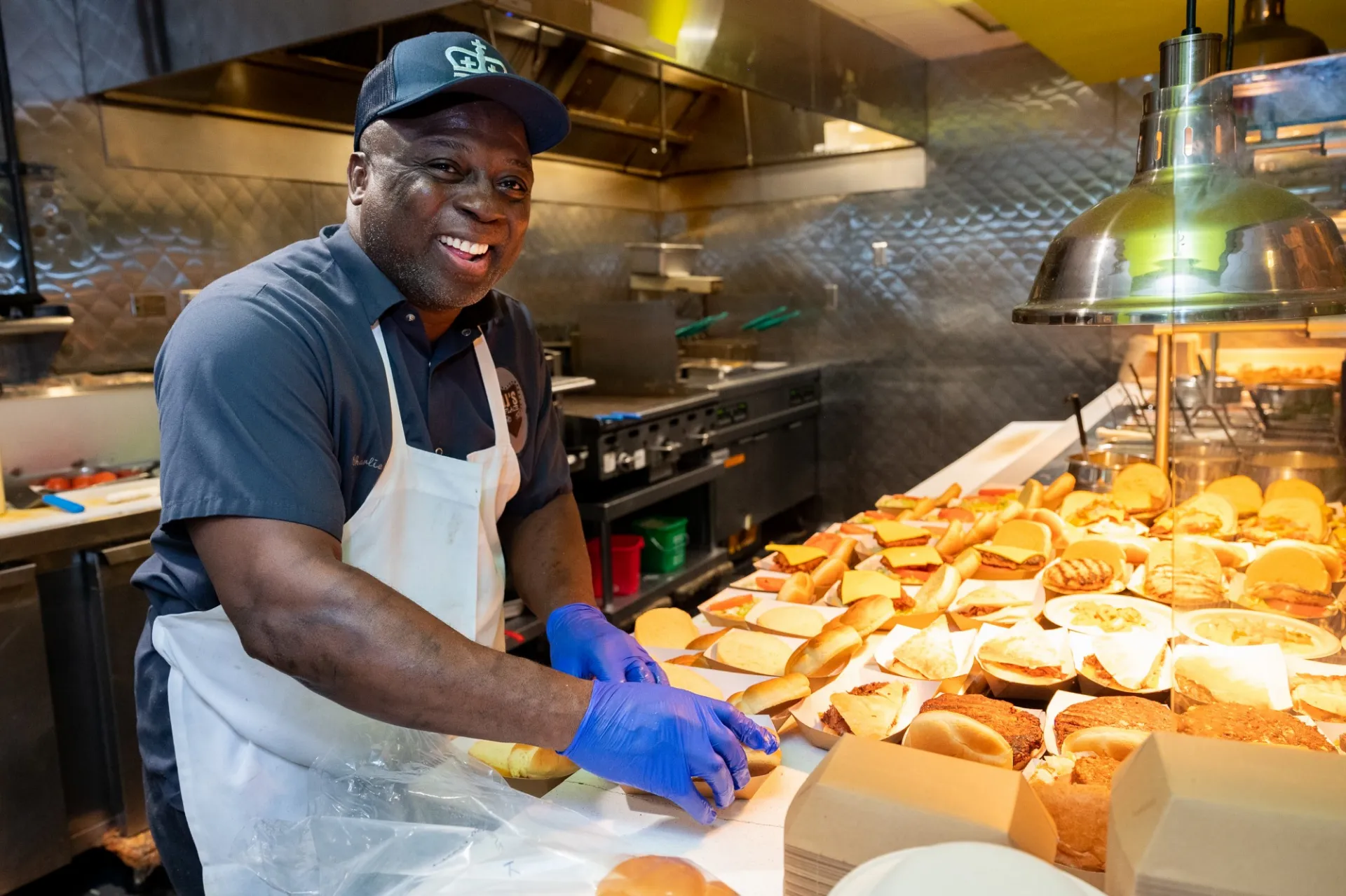 Dining employee making burgers at JJ's Place.