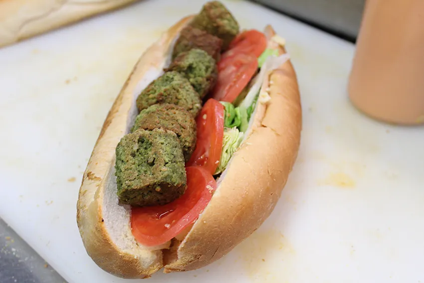 The falafel sub on a cutting board