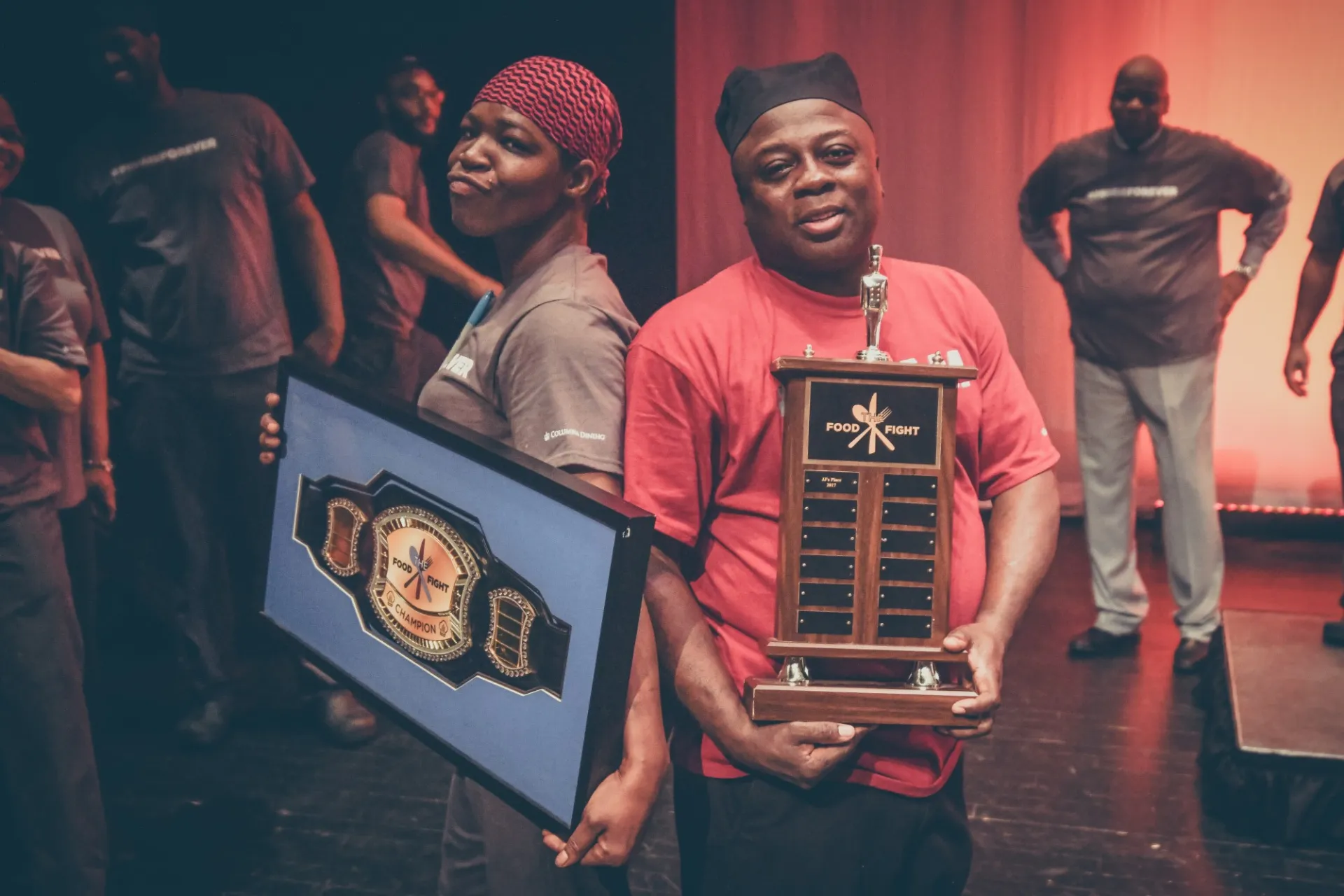 Onicka and Charlie stand back to back on stage at the 2019 Battle of the Dining Halls