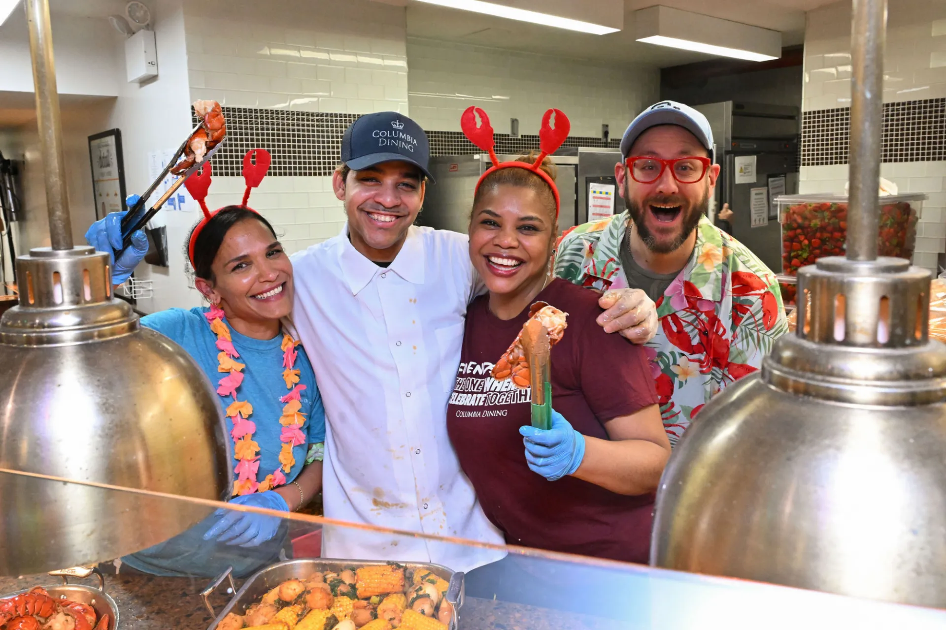 Dining team holding lobster for camera