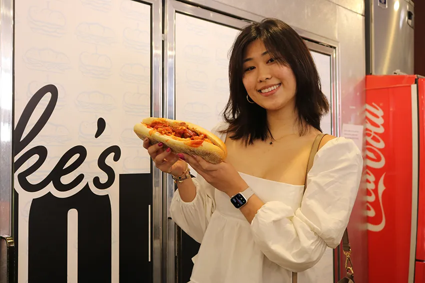 Sarah holding the siracha seitan sub